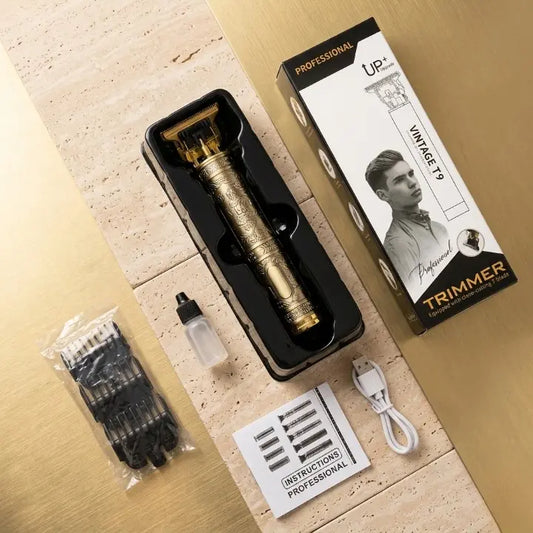Vintage-style gold trimmer with packaging and accessories on a beige surface