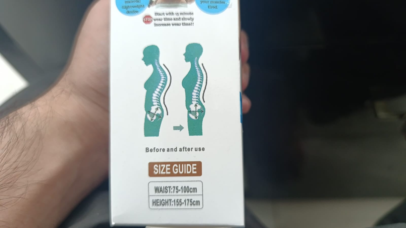 Hand holding a box with size guide graphics on a blurred background