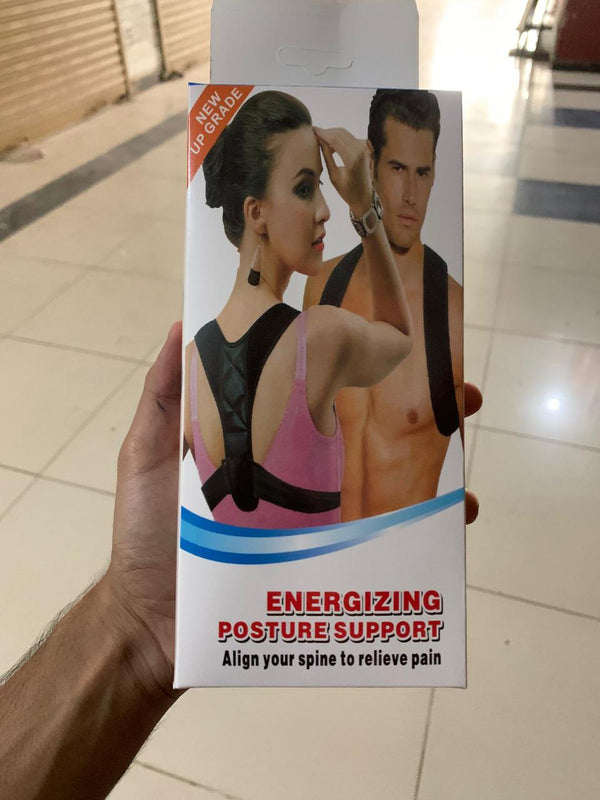 Energizing posture support product packaging held by a hand on a tiled floor.