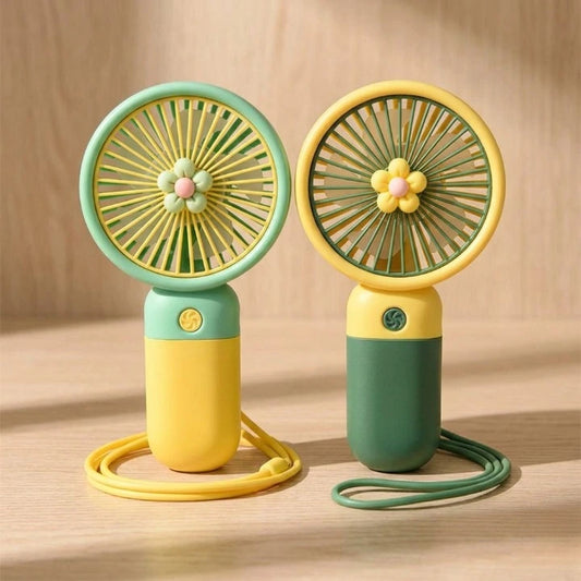 Two small handheld fans with floral designs on a wooden surface