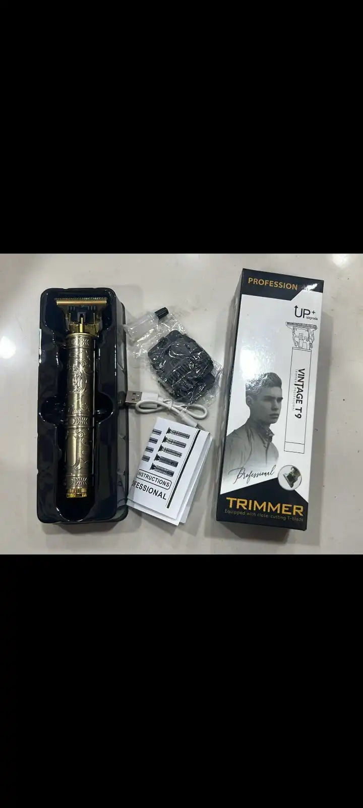 Vintage-style trimmer with packaging and accessories on a light surface

